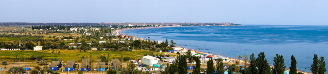 Panorama of a tourist town on shore of the sea in summer
