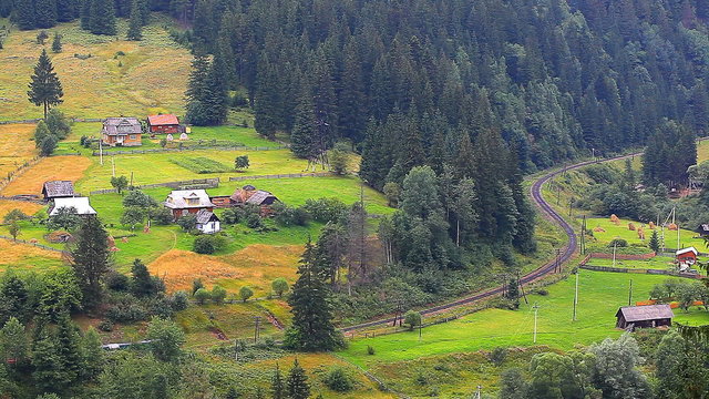 train rides through a village in the mountains