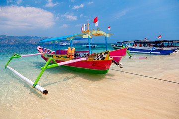 Colorful Indonesian boat at tropical sand beach in sunny day