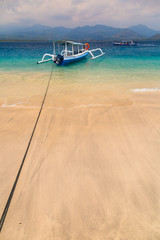 Colorful Indonesian boat at tropical sand beach in sunny day