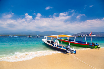 Colorful Indonesian boat at tropical sand beach in sunny day