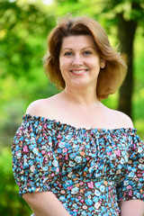 stylish middle-aged woman in the summer park