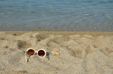 Sun glasses with sea star on a beach