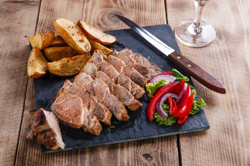 Sliced pork steak with fried potatoes