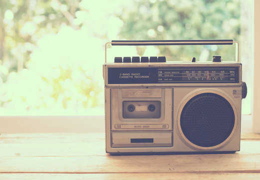vintage radio on table nature background, instagram filter