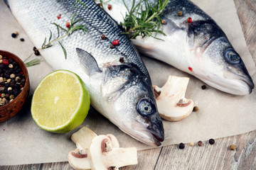 Raw seabass fish on the wooden board