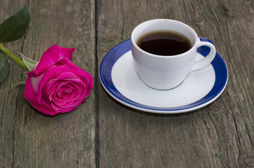 cup of coffee and lonely red rose on a table
