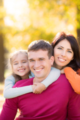 Happy family in autumn park