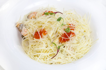 spaghetti with eggs decorated with greenery on a white background