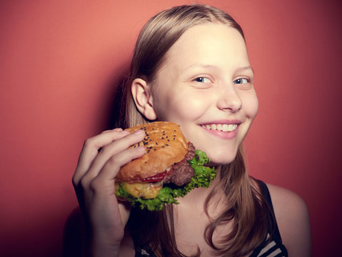 Teen Girl Eating A Burger