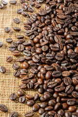 roasted coffee beans on burlap mat