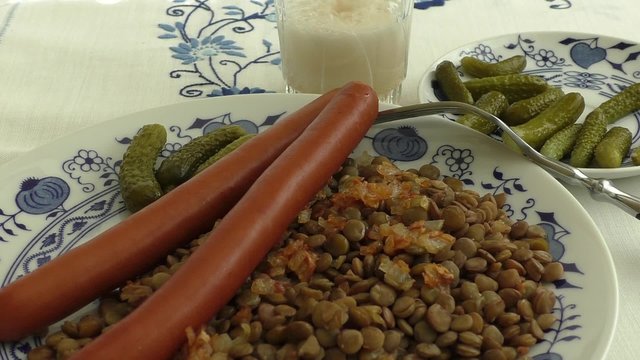 Cooked lentil with spicy sausages and pickles 
