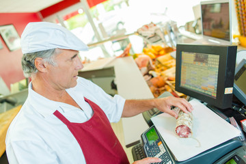 Butcher weighing some meat