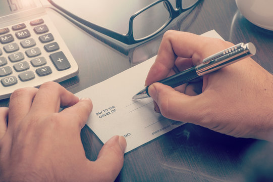Man writing a payment cheque