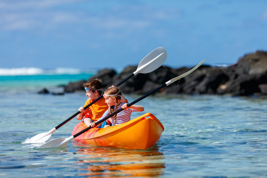Kids Kayaking In Ocean