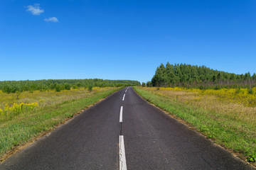 Country asphalt highway with one line of dashed white road markings