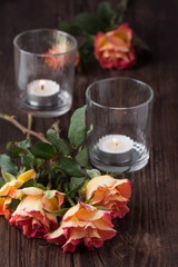 orange roses with lightning candle