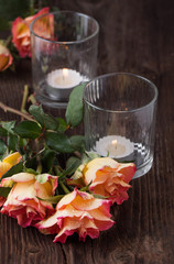 orange roses with lightning candle