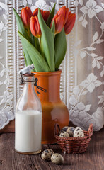 quail egg with bottle of milk and flowers