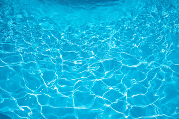 Blue water rippled background in swimming pool