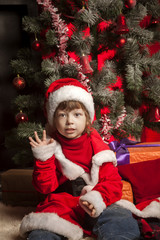 happy boy with christmas gift near Christmas tree
