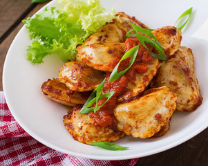Delicious ravioli with tomato sauce and green onions