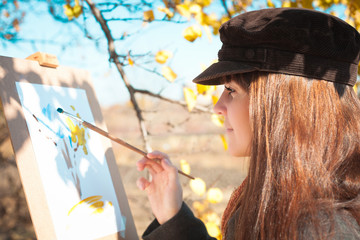 Portrait of a young beautiful woman with a brush in her hand