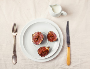 Figs and honey on white plate