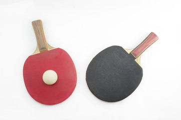 Two table tennis rackets and a ball on white