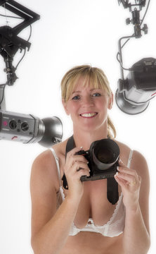 Model taking photos in a studio surrounded with lights