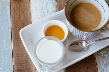 Set of Hot Coffee, Milk and Honey On Wood Table.