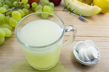 Effervescent tablets and dissolved tablet in a glass with bunch