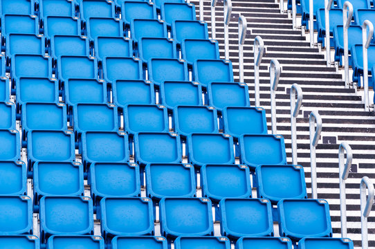 rows of blue seats in a stadium