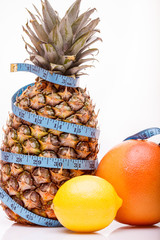Pineapple grapefruit lemon and measuring tape