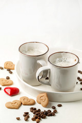 Tow cup of cappuccino with cookies as hearts