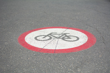 Bicycle path sign on the street. Photo was taken on a nice sunny day. Summer time. Focus is on the middle of the sign.
