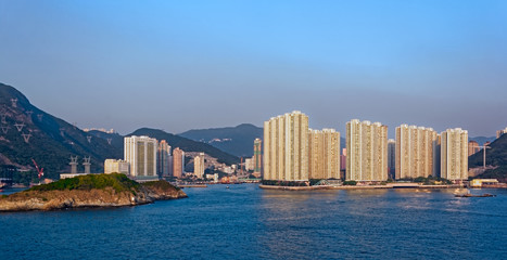 Fototapeta premium Sunset view to residential apartments building in Hong Kong seaf