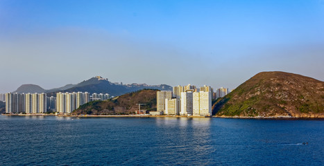 Fototapeta na wymiar Sunset view to residential apartments building in Hong Kong seaf