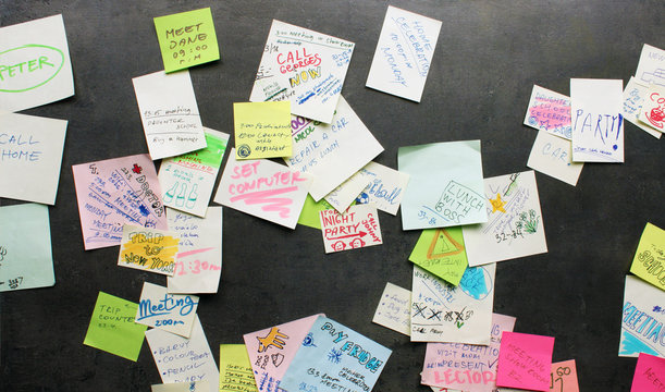 Post-it notes on dark background - busy concept
