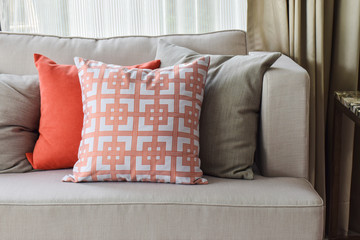 Chinese pattern  in orange and deep orange and gray pillows on l