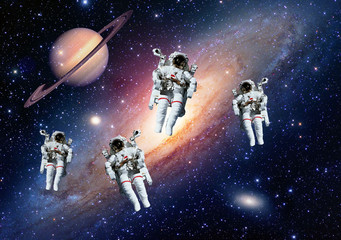Astronauts spaceman outer space solar system saturn planet universe. Elements of this image furnished by NASA.