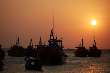 Fototapeta premium fishing boats in the sea at sunset