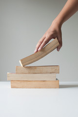 Hand picking a book.