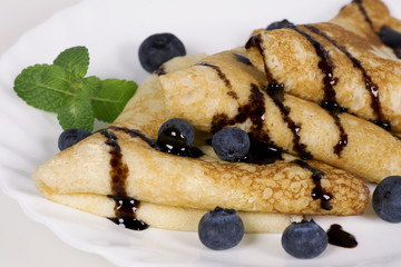 Pancakes with blueberries and chocolate sauce