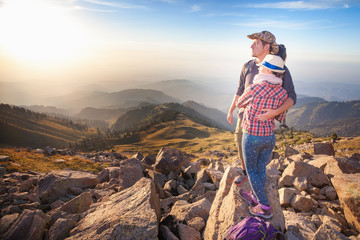 Climbing young couple at top of summit with aerial view