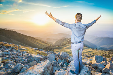 businessman at the top of the mountain sitting and thinking