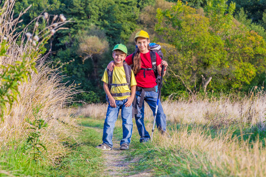 Two traveling kids with backpacks