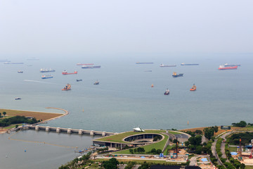 Marina Barrage dam and cargo ships lying in the roads off the coast of Singapore
