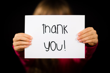 Child holding Thank You sign