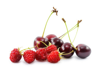 cherries and raspberries isolated on white background